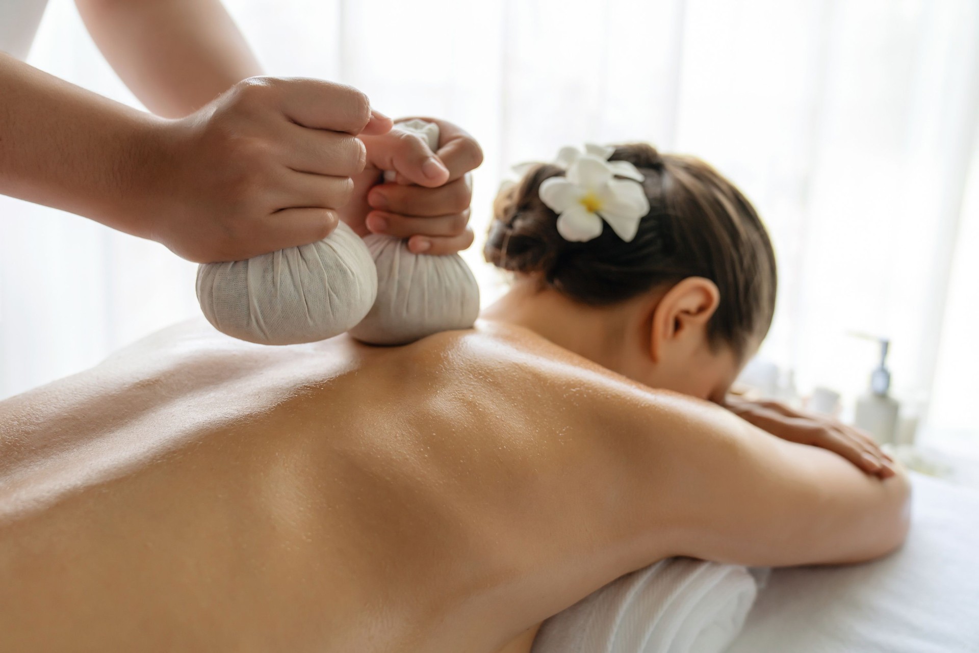 Hot herbal ball spa massage body treatment at day spa . Quiescent